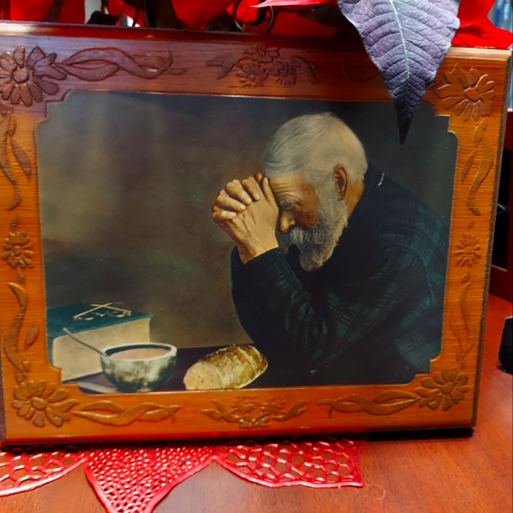 Wooden picture of old man praying